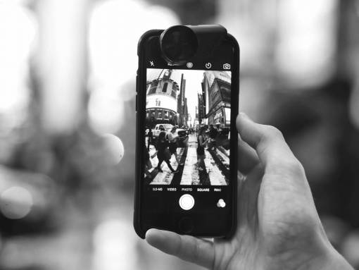 A person holds a phone to take a picture
